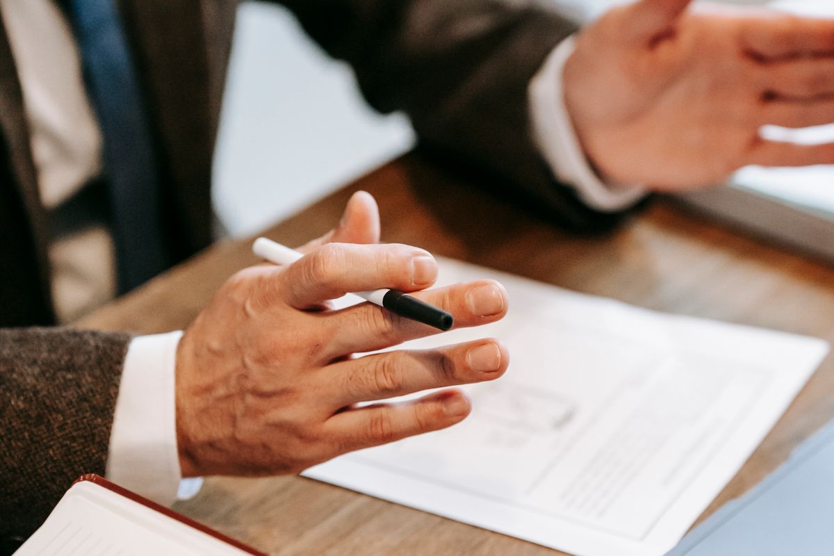 Adviser explaining the rent-to-serviced-accommodation model over documents