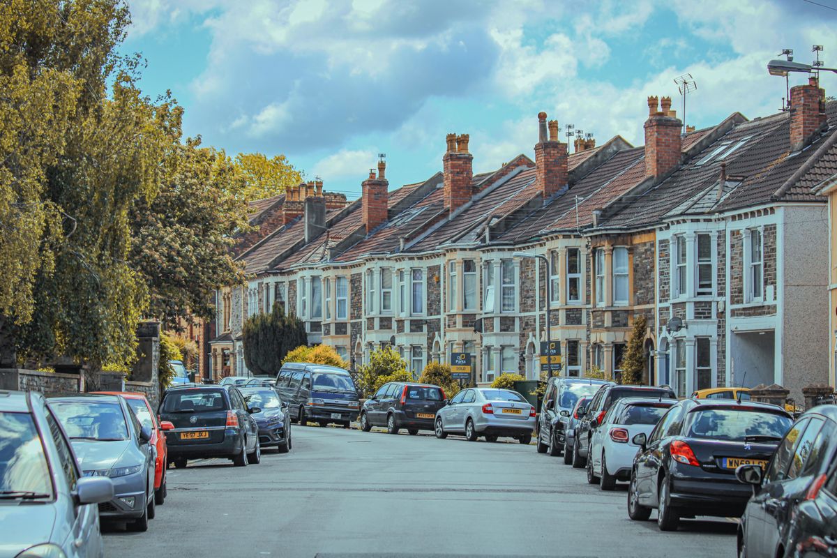 Terraced houses and parked cars on an inner city residential street