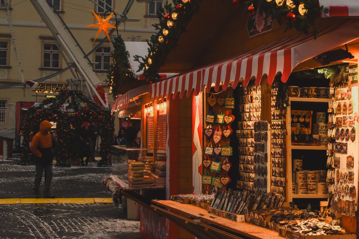 Wooden Christmas market stall lit up in the evening