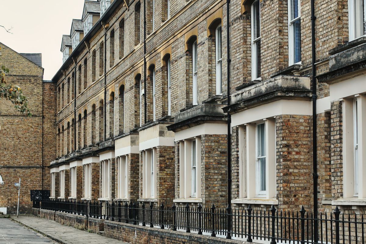 Long row of brick terraced houses on a northern residential street