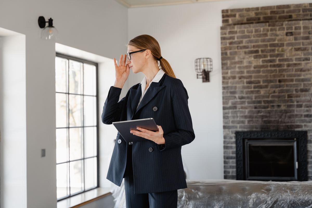 Assessor with a tablet walking through a property during a guaranteed rent assessment