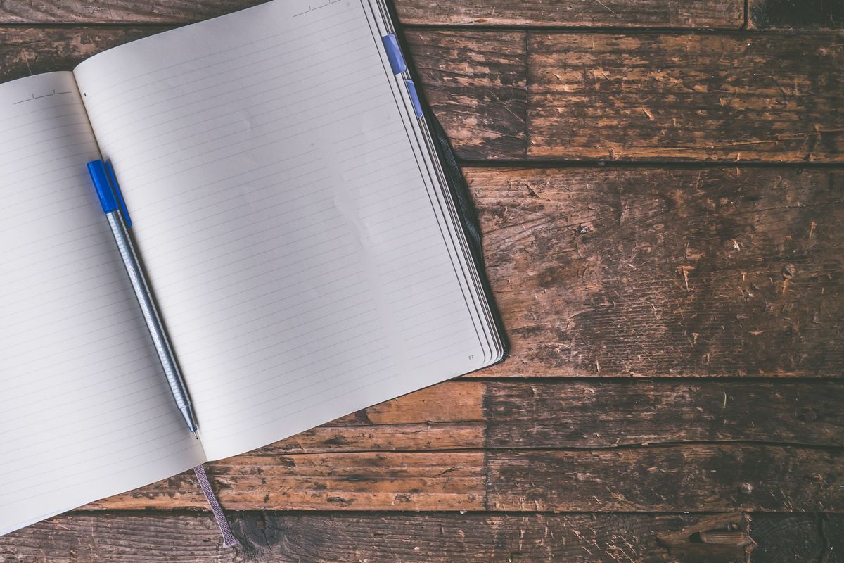 Open notebook and pen ready for the questions to ask a guaranteed rent company