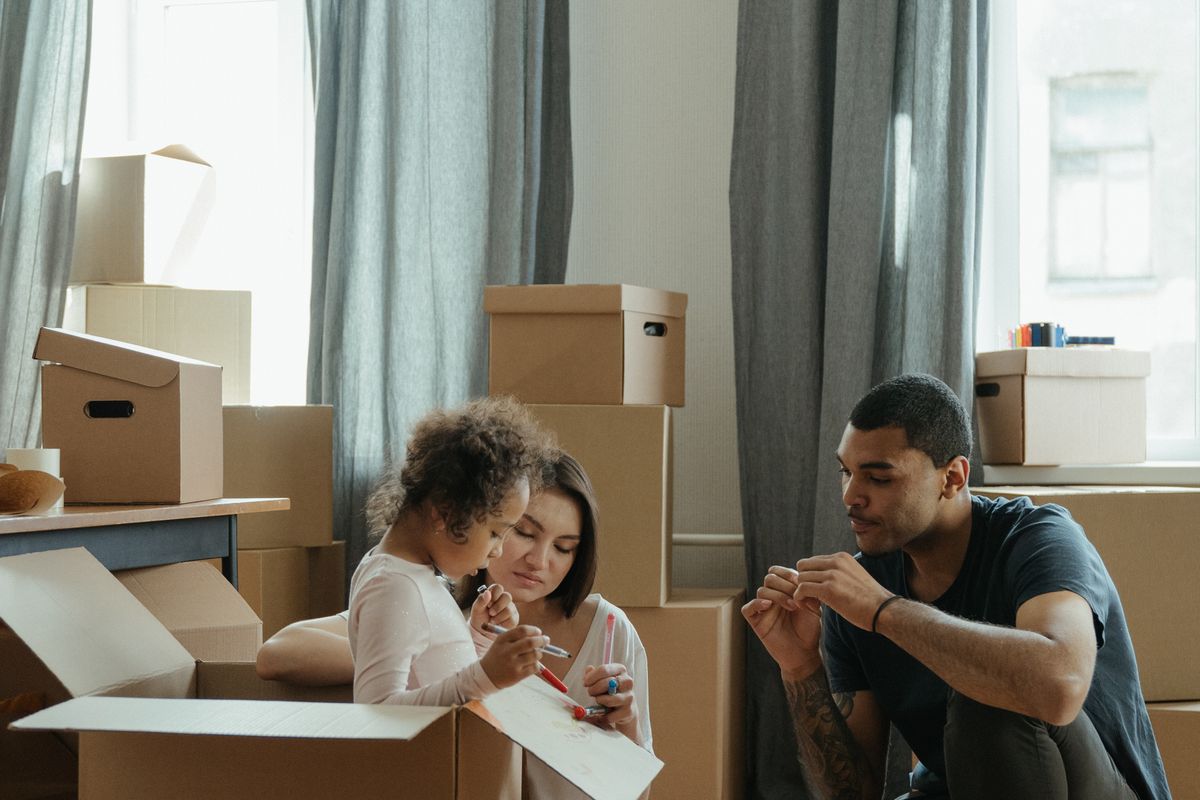 Family unpacking boxes in a new home after relocating to Manchester