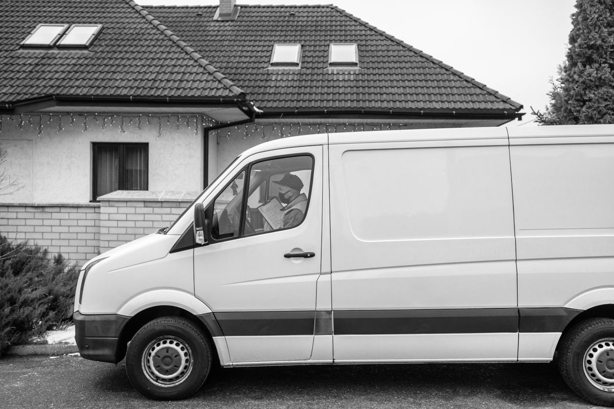 Work van parked beside a house, representing van parking at contractor accommodation in Wythenshawe