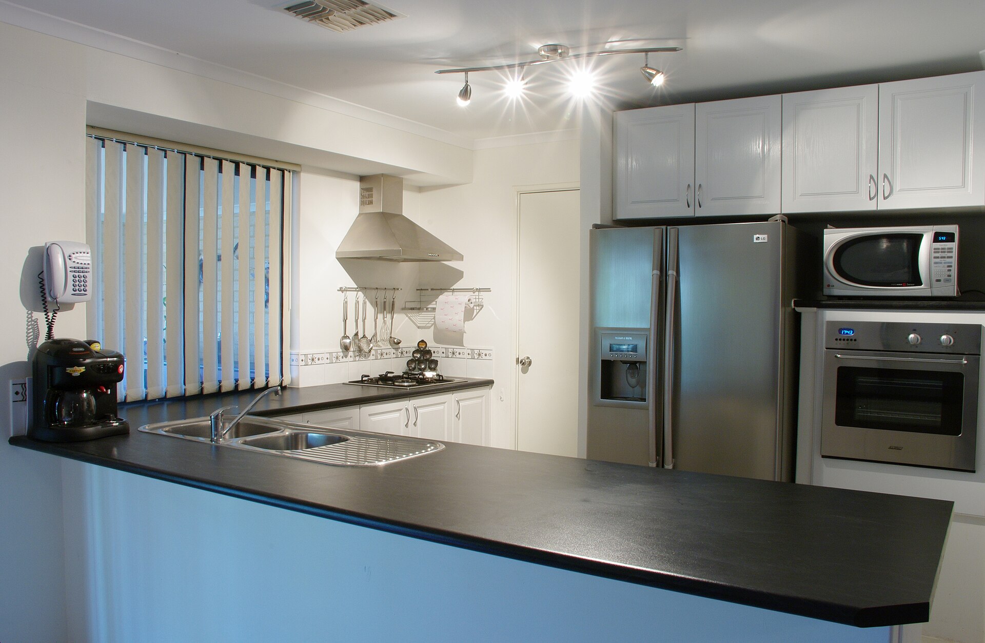 Letting agent handover paperwork beside a Manchester property kitchen
